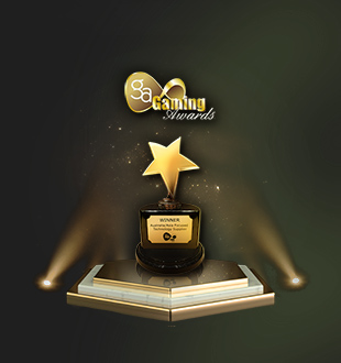 A gold trophy shaped like a star, placed on a pedestal with the word 'WINNER' inscribed on it, illuminated by spotlights displayed above against a green background.